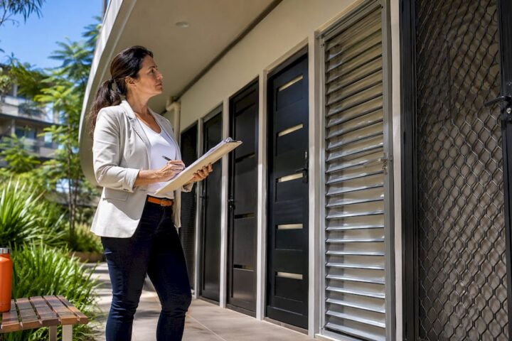 Building manager examining apartment security doors