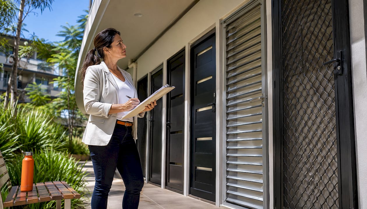 Building manager examining apartment security doors